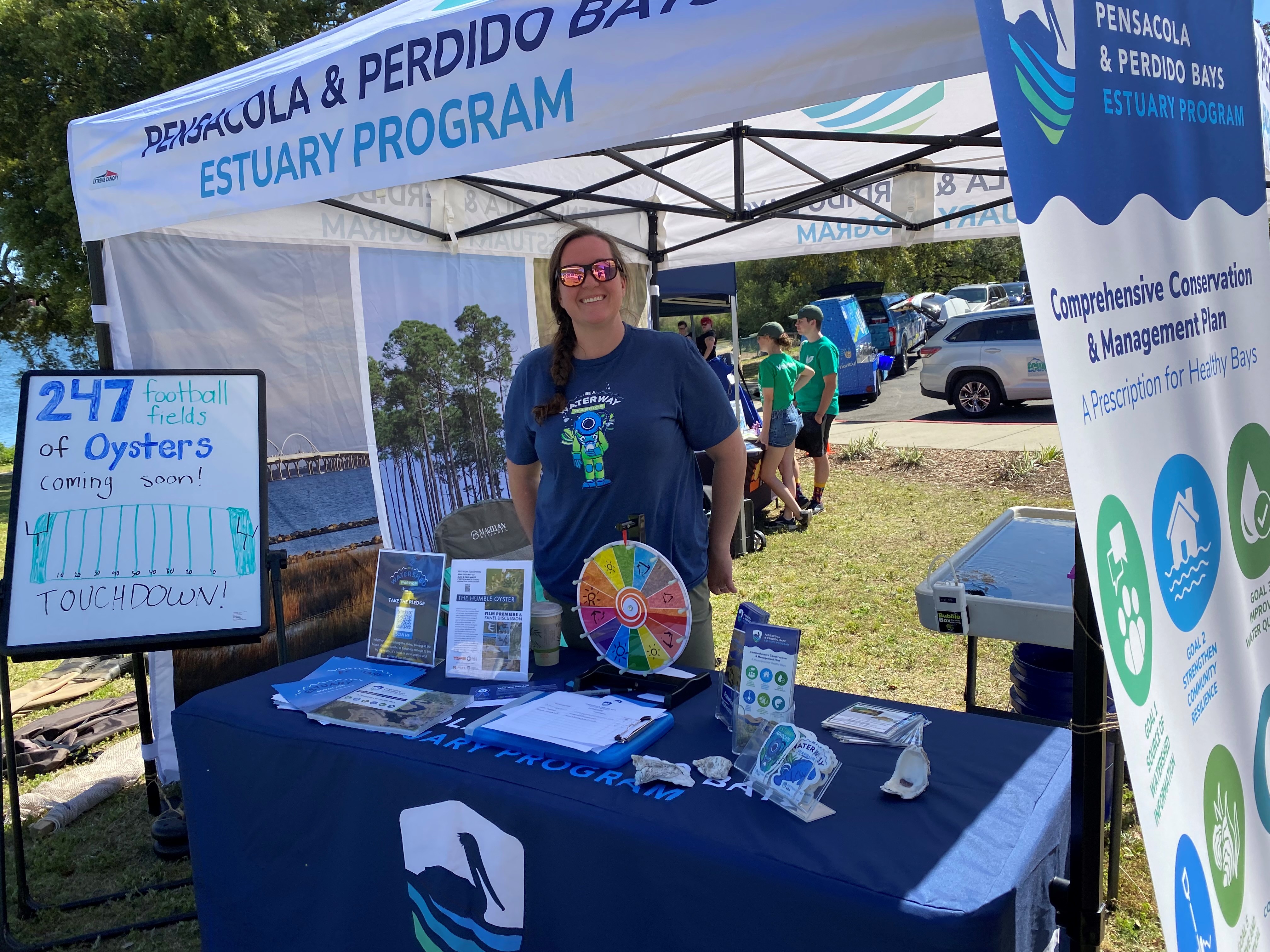 Woman standing behind table at educational booth