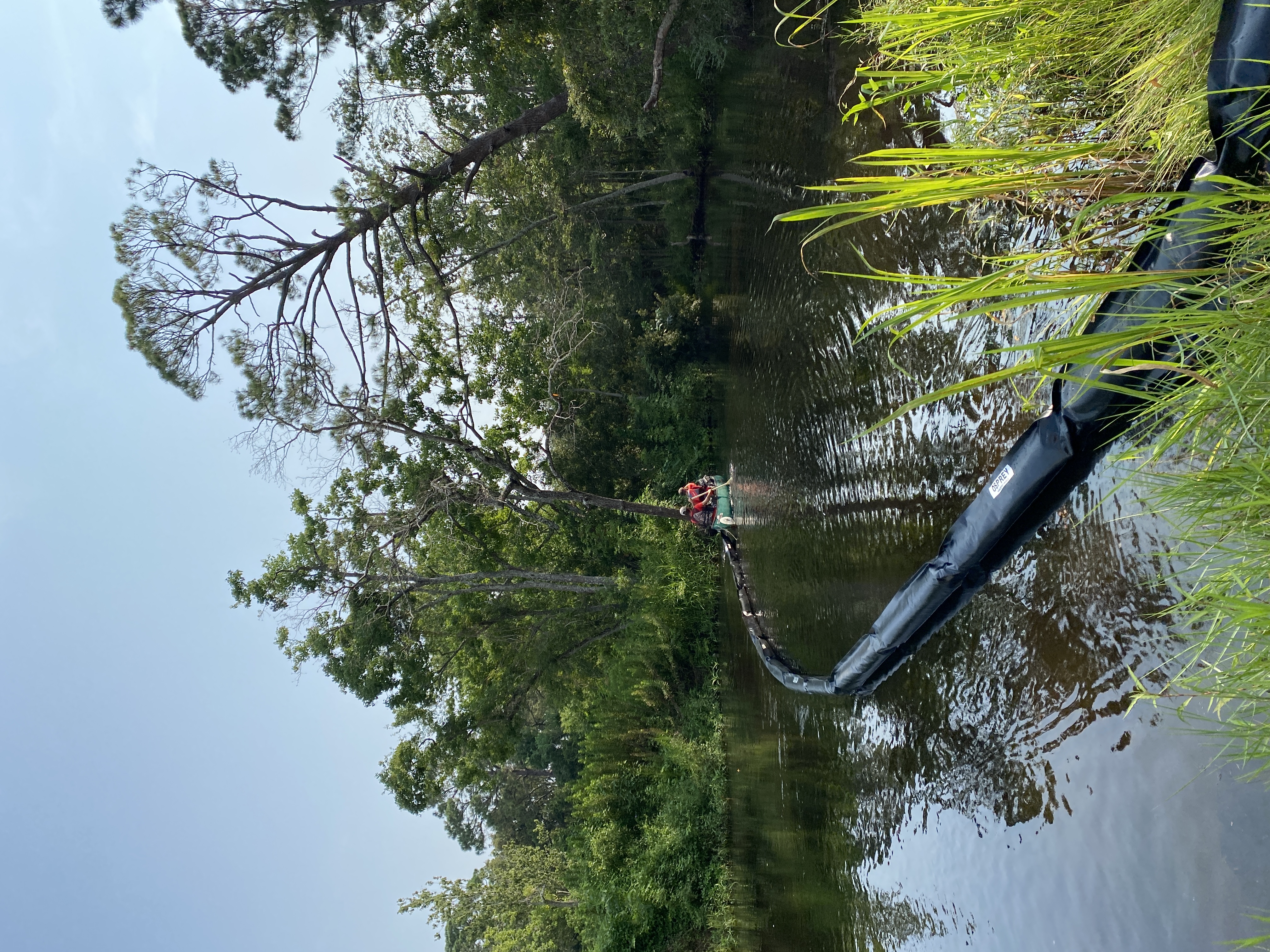 Deploying litter boom by canoes