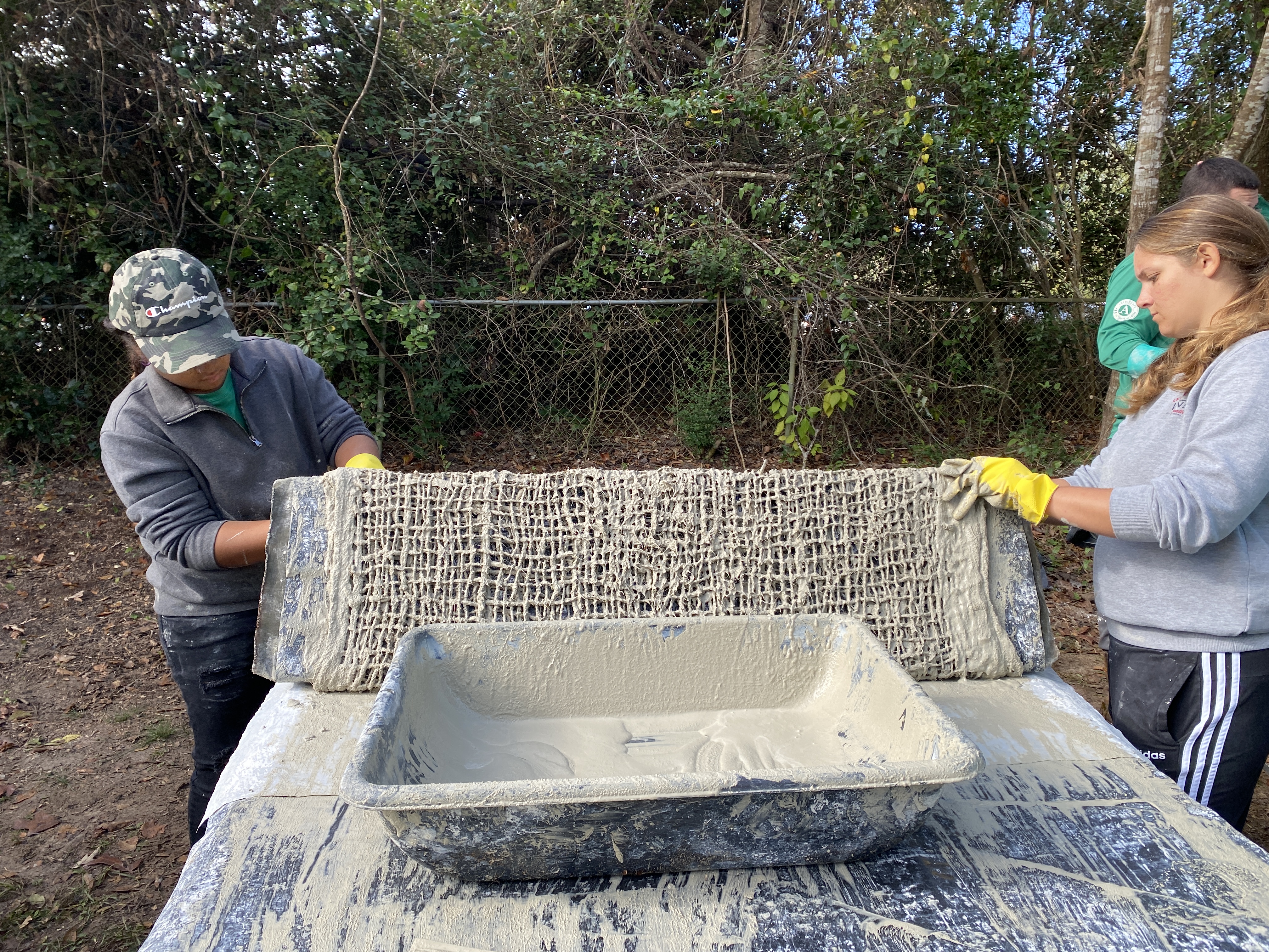 OysterCorps members wrapping jute around prism mold