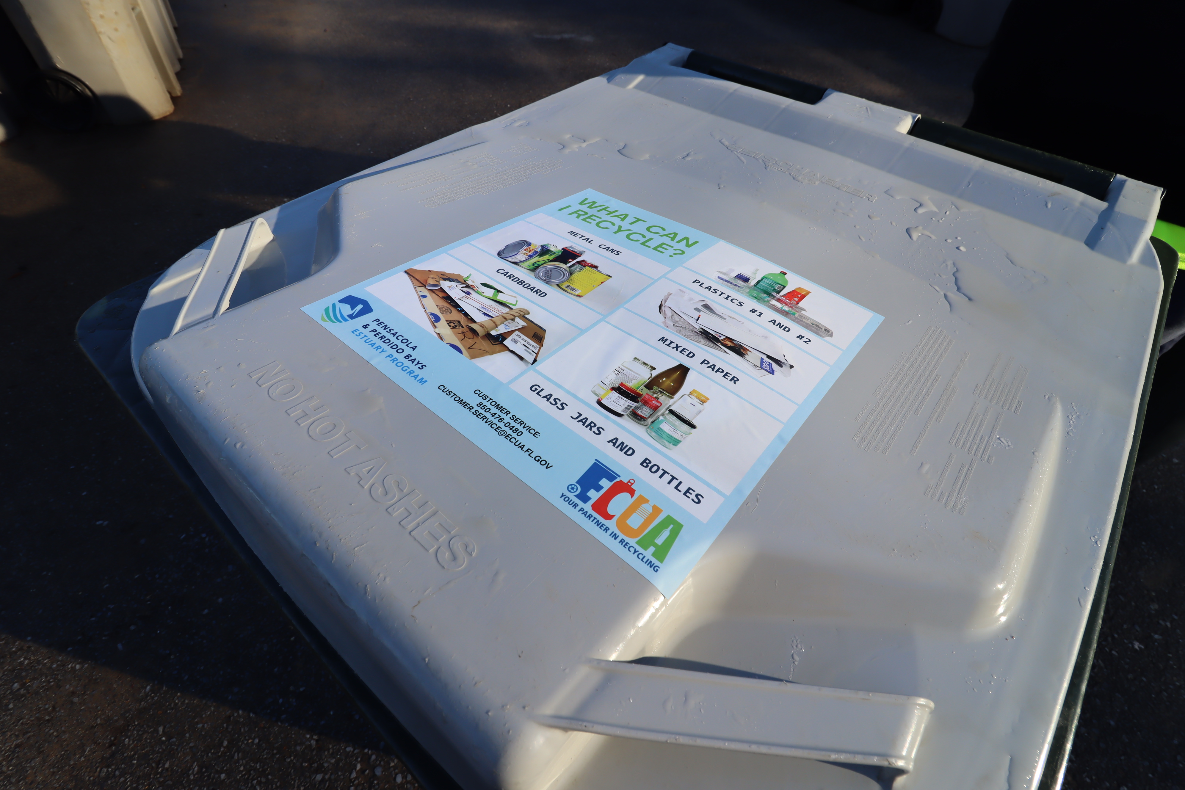 Educational recycling sticker on recycling bin