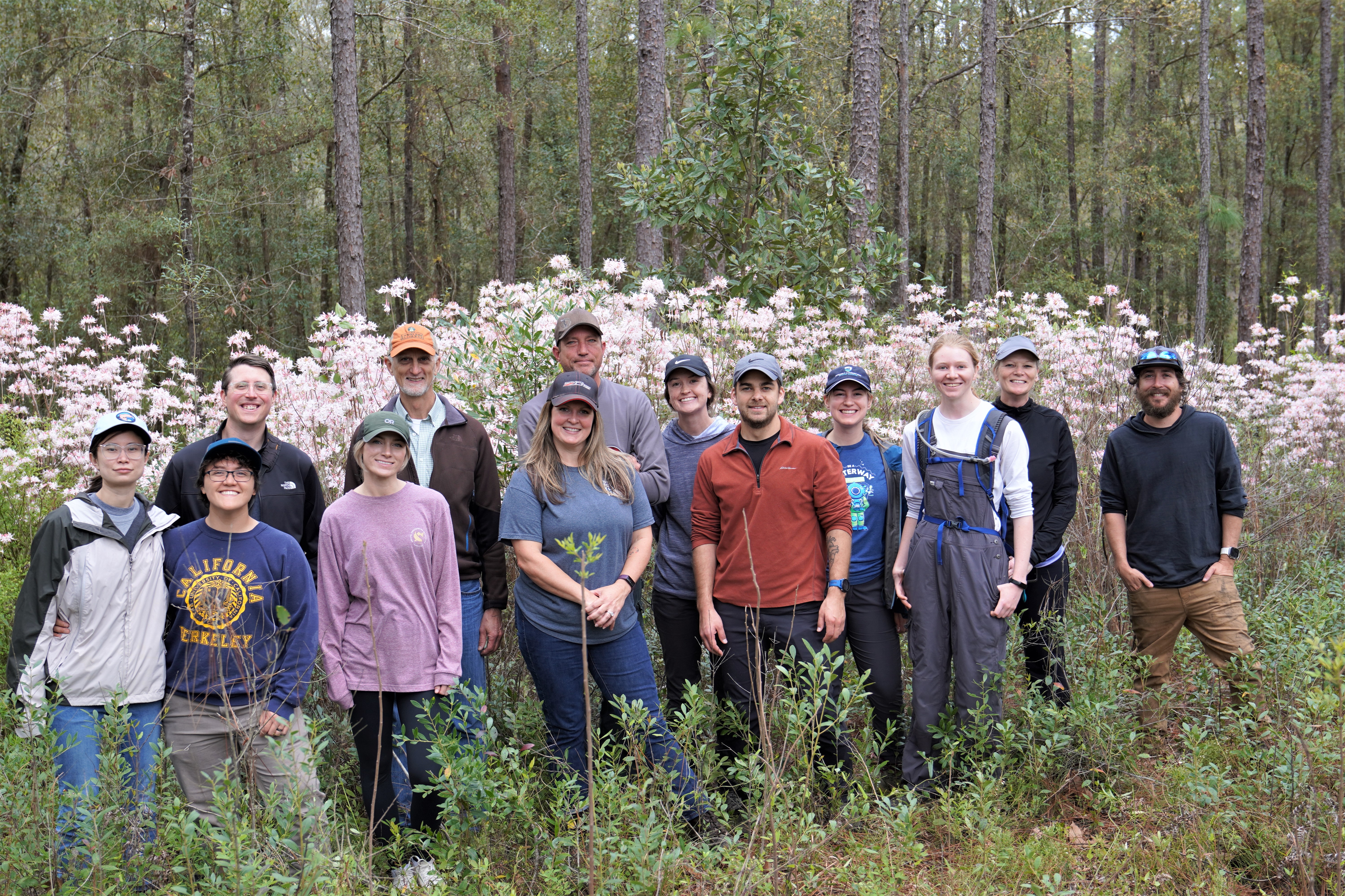 Group of people standing in front of flowering native azaleas