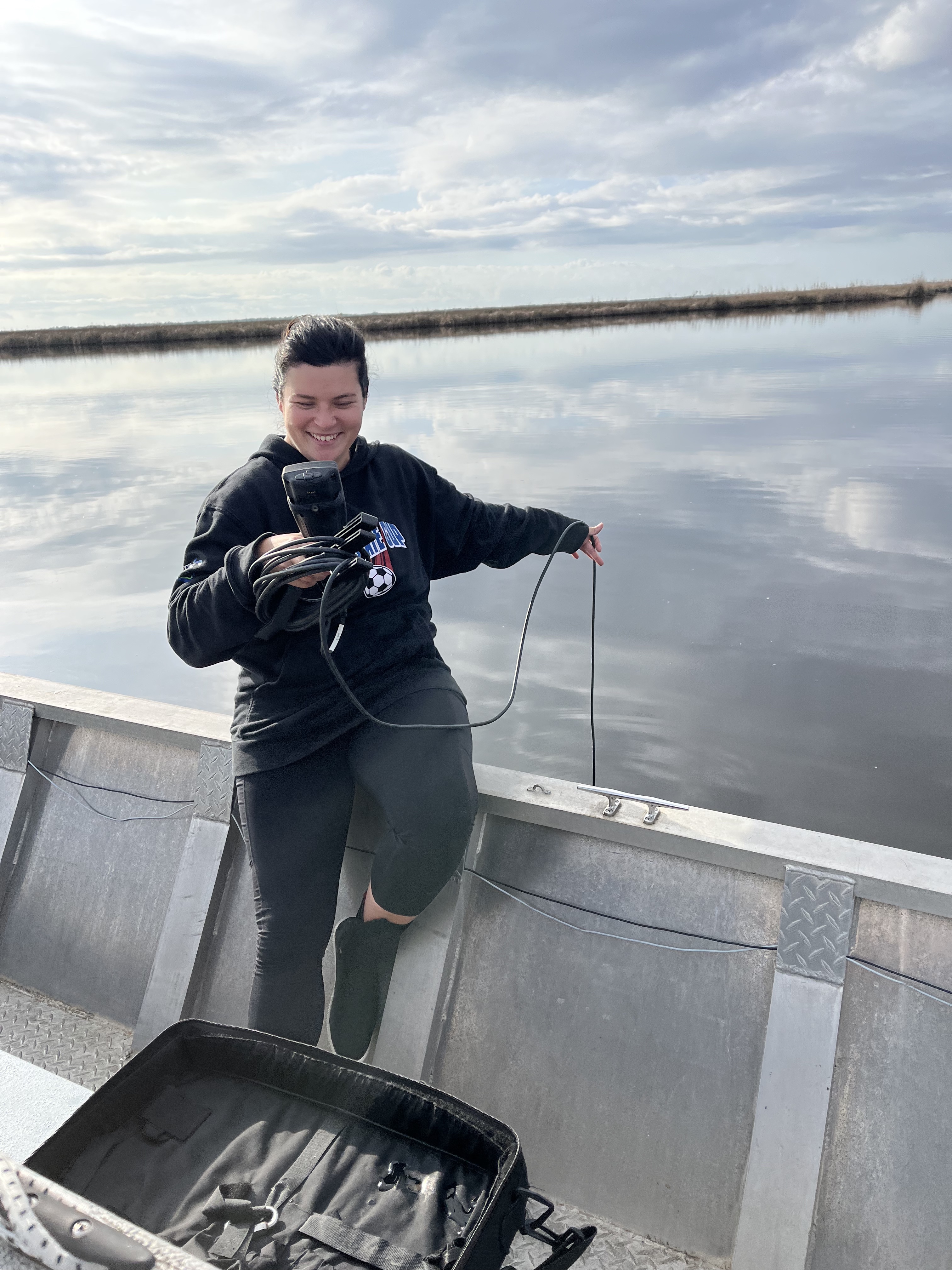Researcher using YSI off of boat